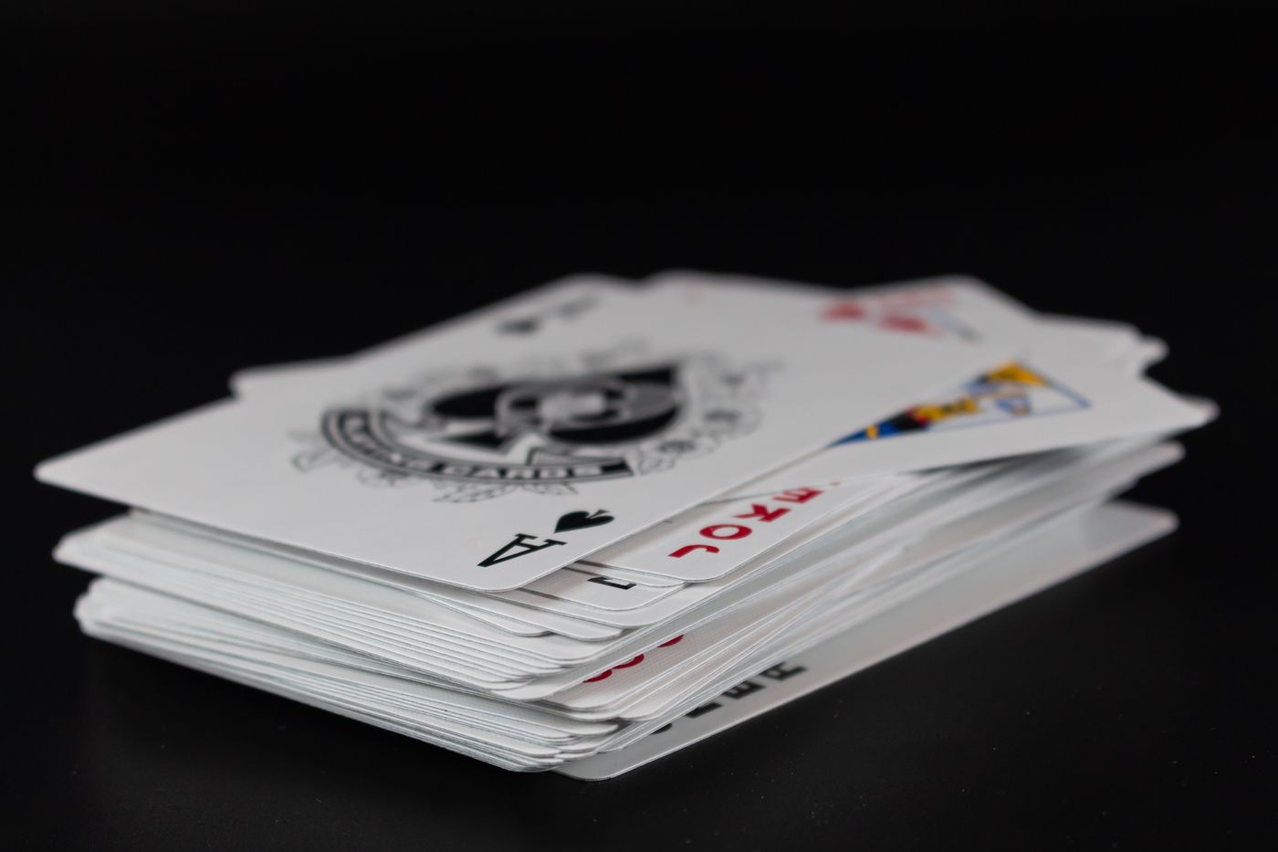 A stack of playing cards with an ace of spades
