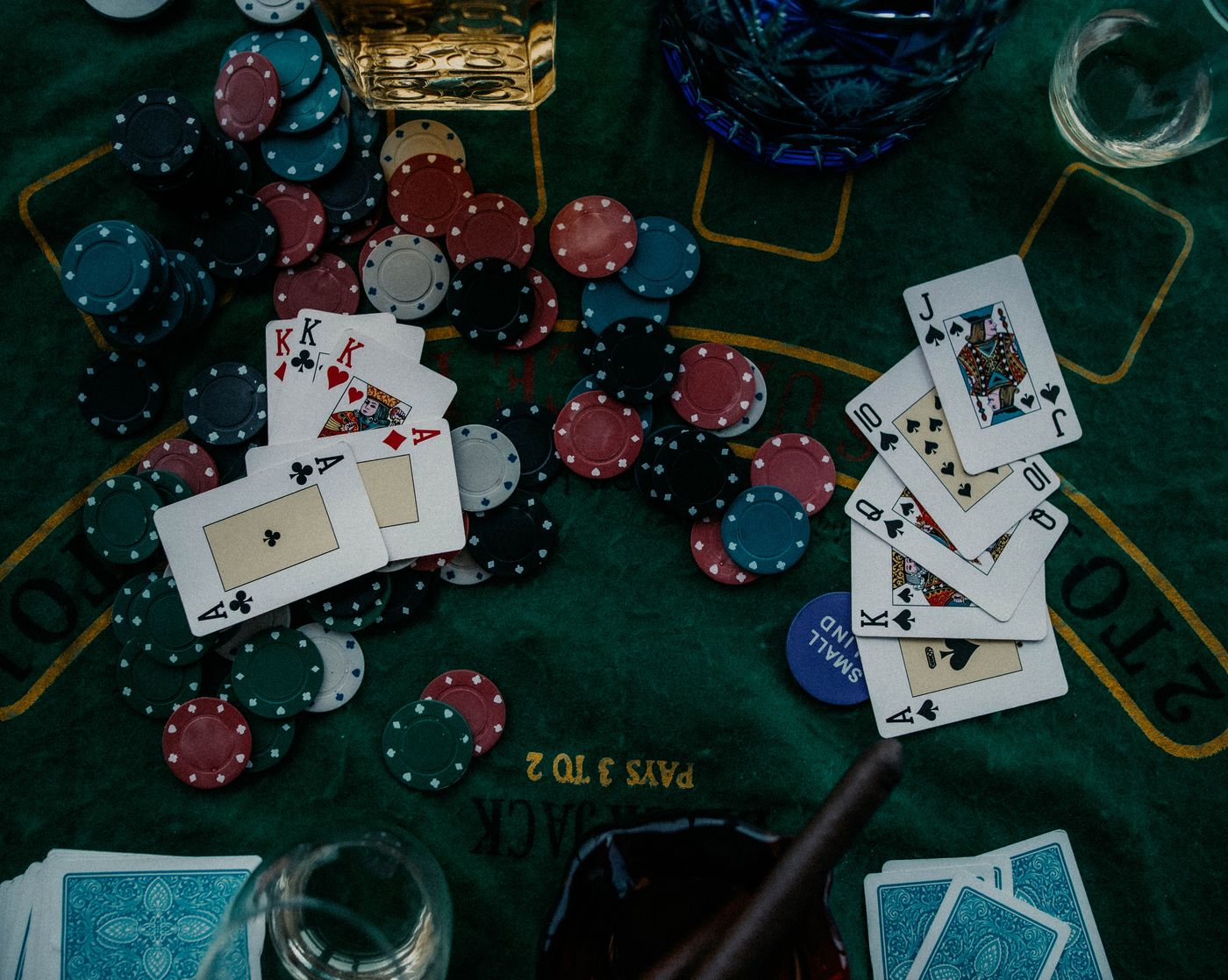 Playing cards and chips on a green poker table