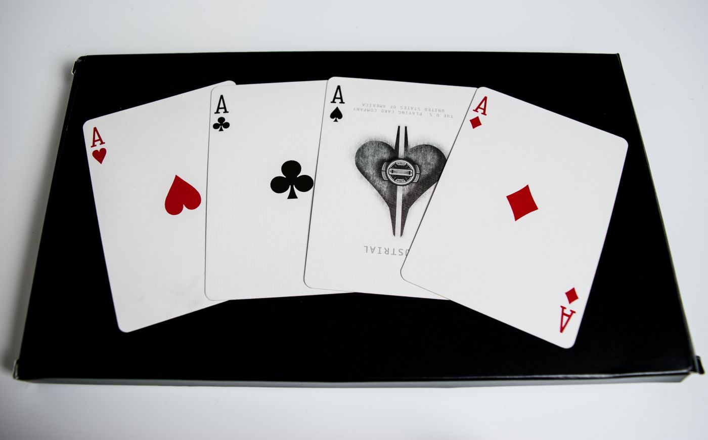 Four aces on a dark surface